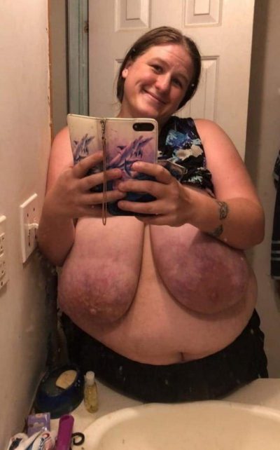 BBW wife with saggy breast exposed take nude selfie in the mirror at home. Mature fatty bares her massive saggy tits for naked selfie