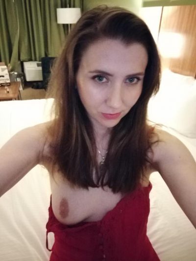 Amateur wife tempts with a beautiful look and natural boob. Very erotic MILF without bra with unveiled one tit takes a selfie
