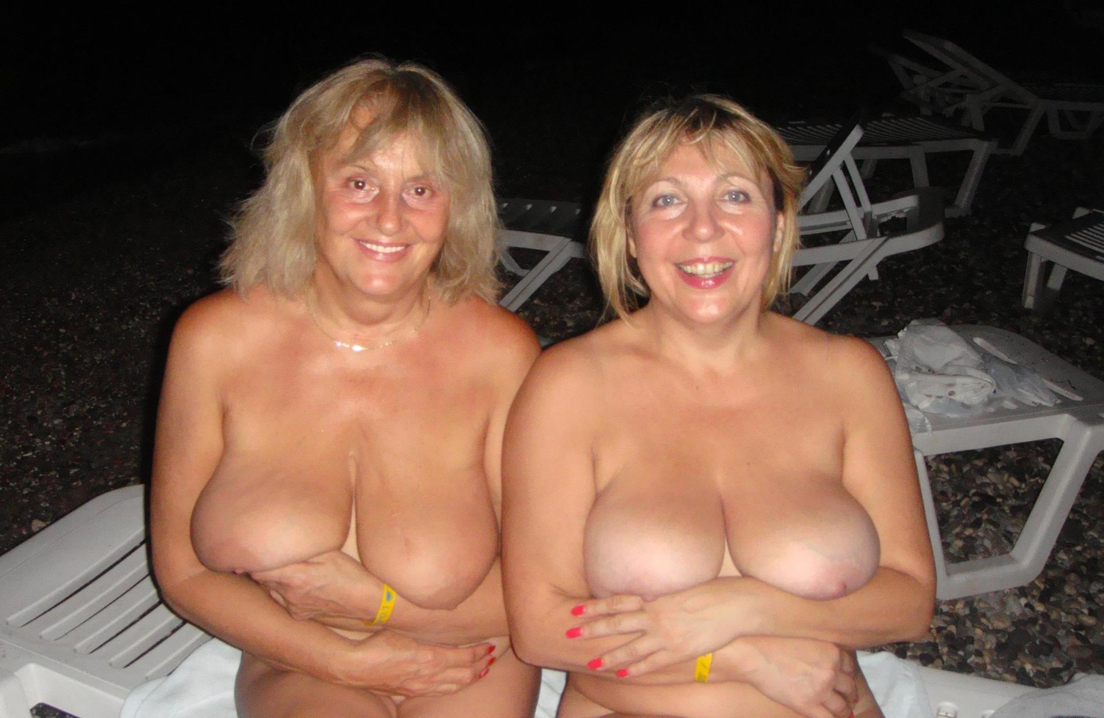 Mature huge juggs are waiting for you! Beautiful two gilfs show off gorgeous nude natural tits while sitting on a sun lounge
